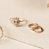 Sunburst Morganite Halo Ring - Evelina with oval morganite center and diamond halo set on a delicate gold band on neutral surface