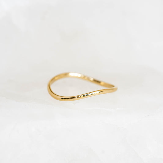Wavy Ring 14k Gold - Brielle displayed on a soft white surface with gentle lighting highlighting its smooth curves