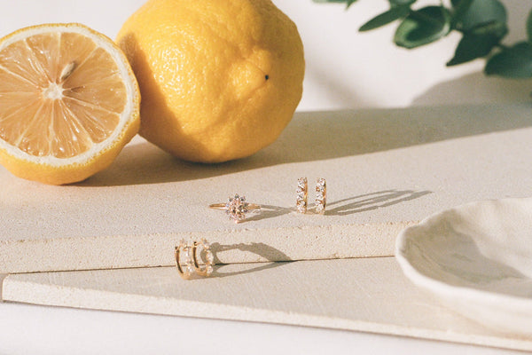 Two lemons on a white surface with a minimal background