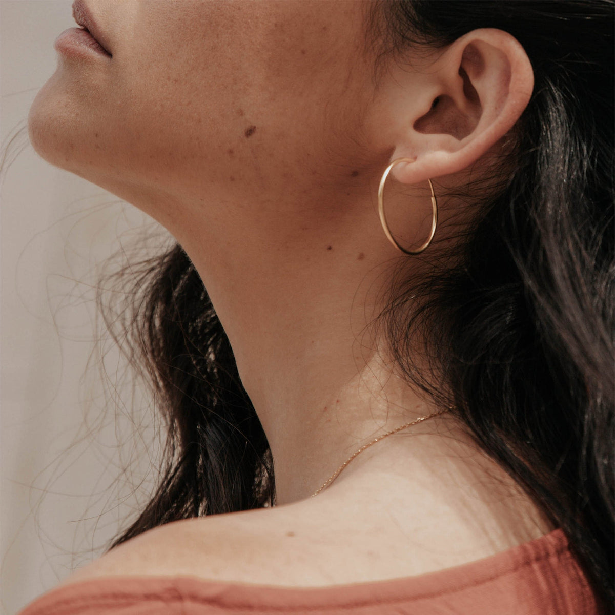 Gold hoop earrings with hinged back