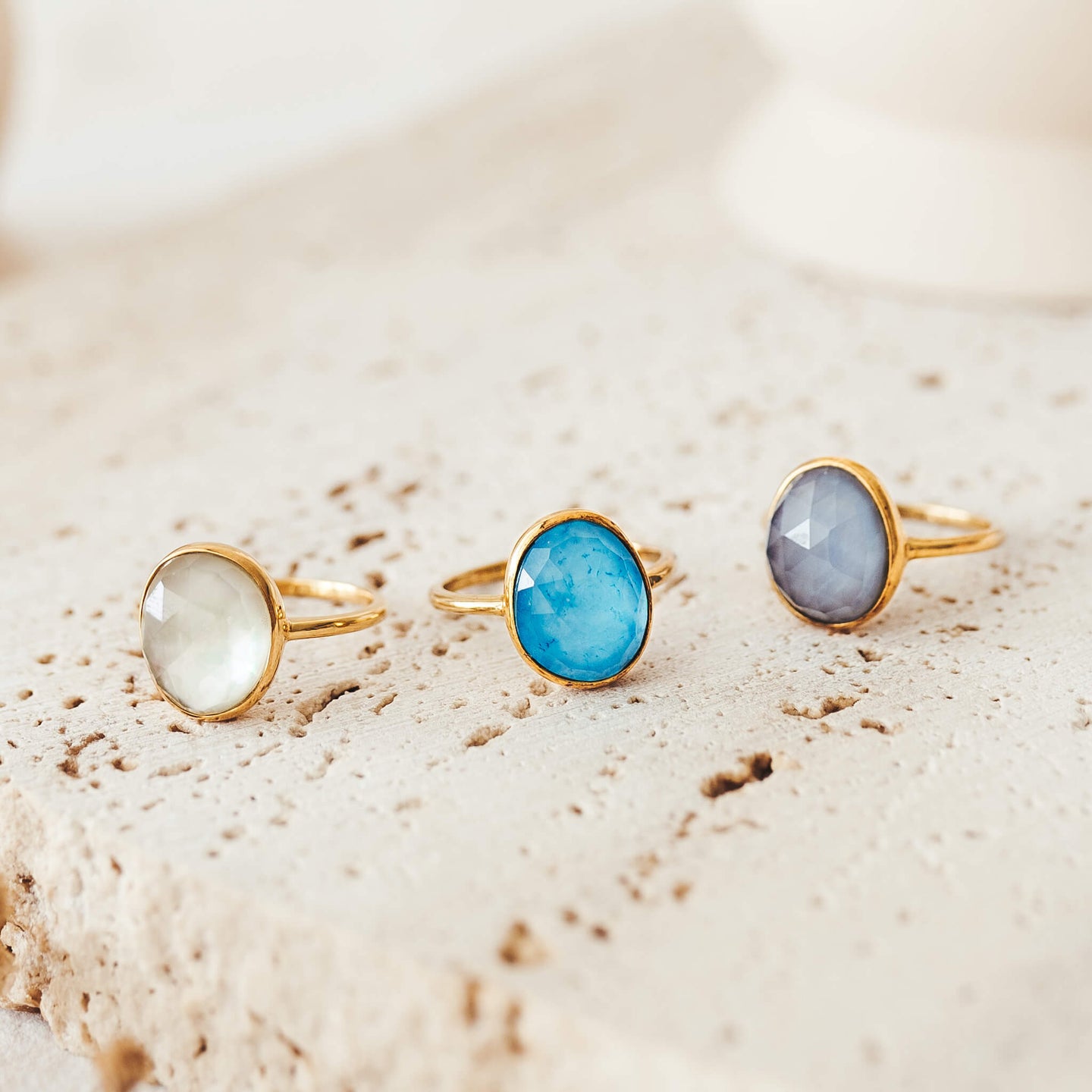 Three gemstone doublet rings in bezel setting