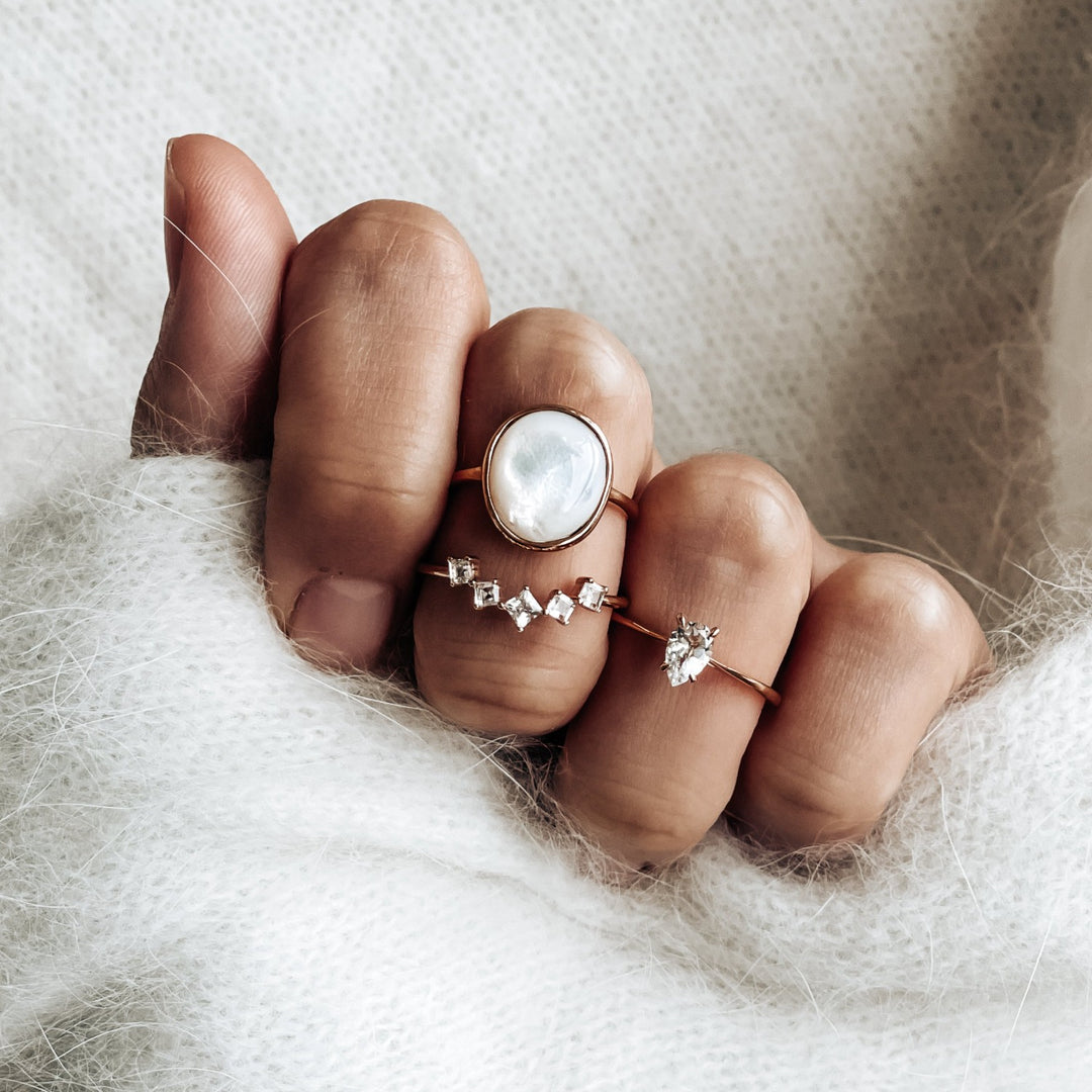 Three gold vermeil rings with mother of pearl and white topaz gemstones 