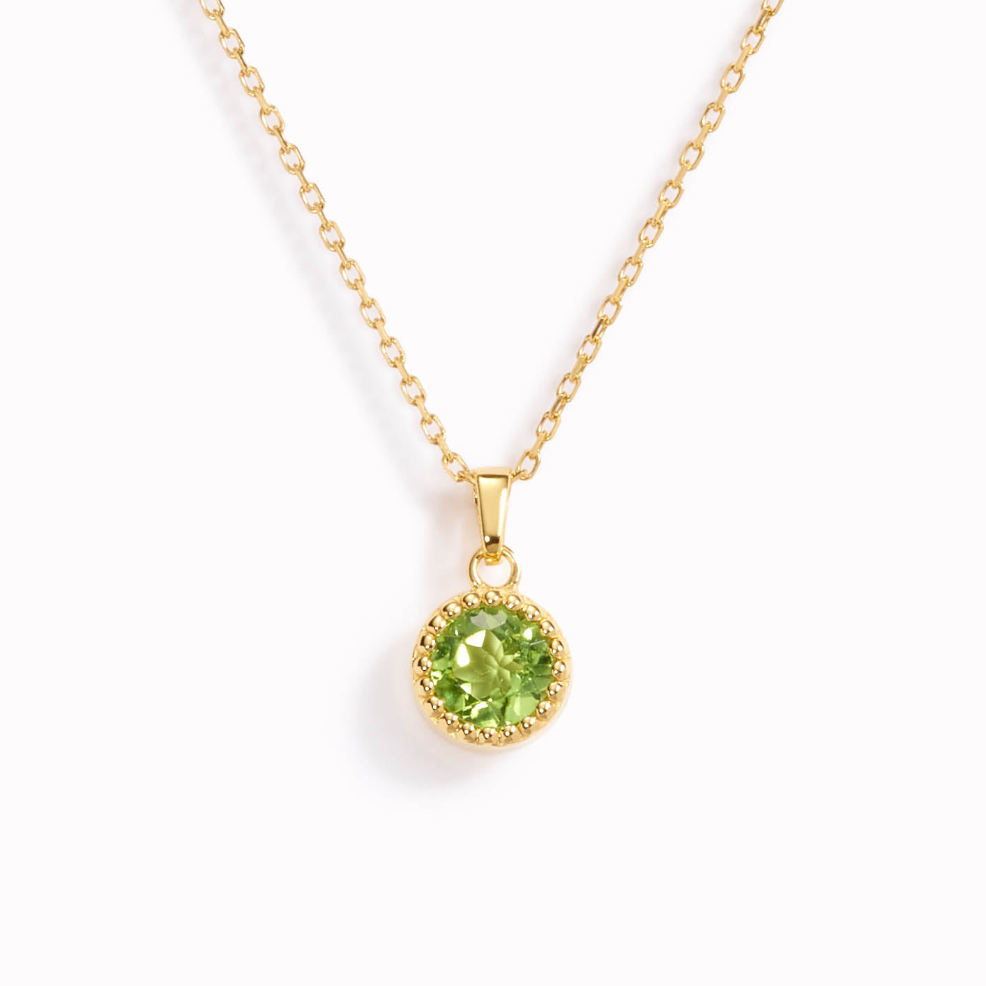 August birthstone necklace with bezel set peridot pendant on a gold chain