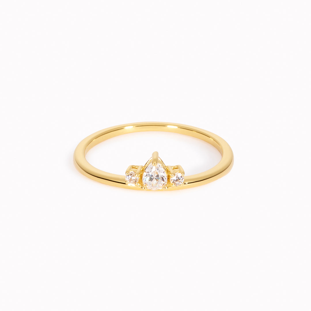 Gold ring with pear-cut and round white gemstones