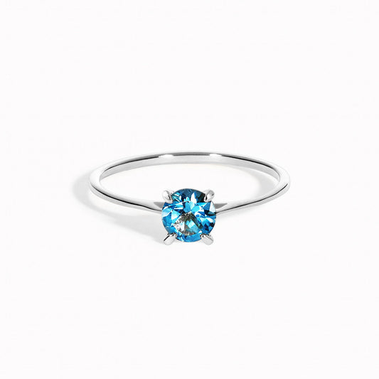 Round london blue topaz solitaire ring on a silver band