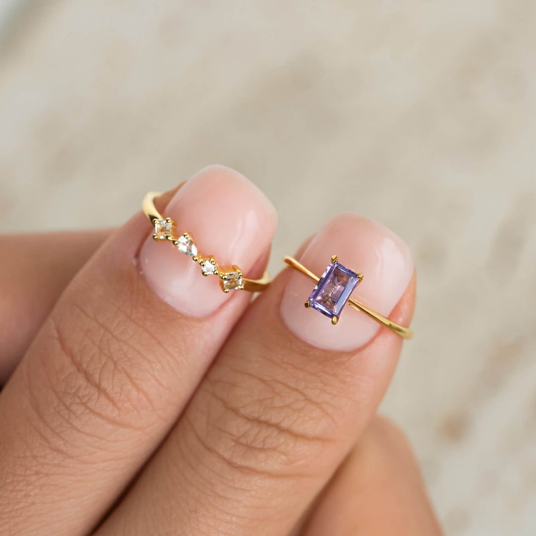 Baguette Ring Amethyst - Charlotte featuring a delicate gold band with a rectangular purple amethyst stone on finger