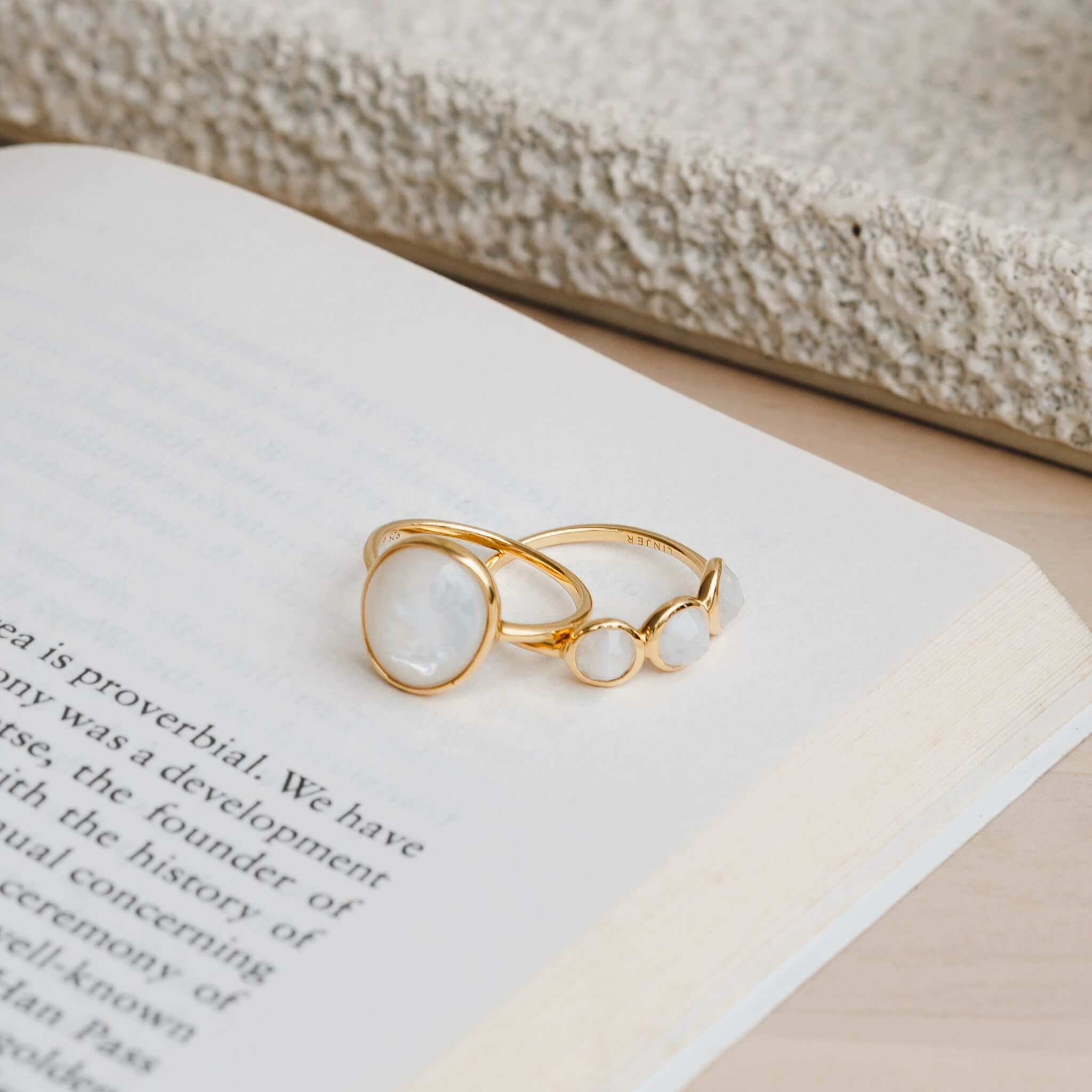 Two gemstone rings with mother of pearl and moonstones