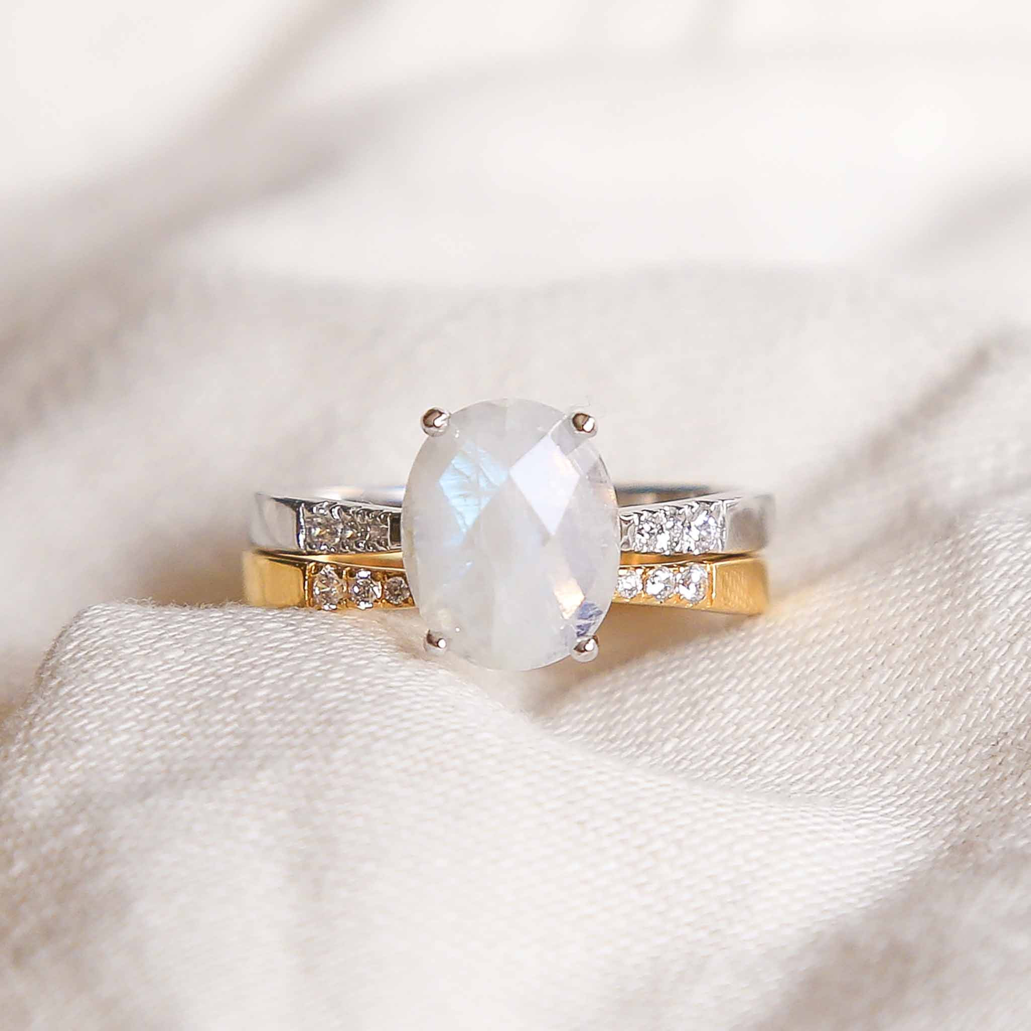Cubic zirconia gemstone accents on open gold band stacked with silver band