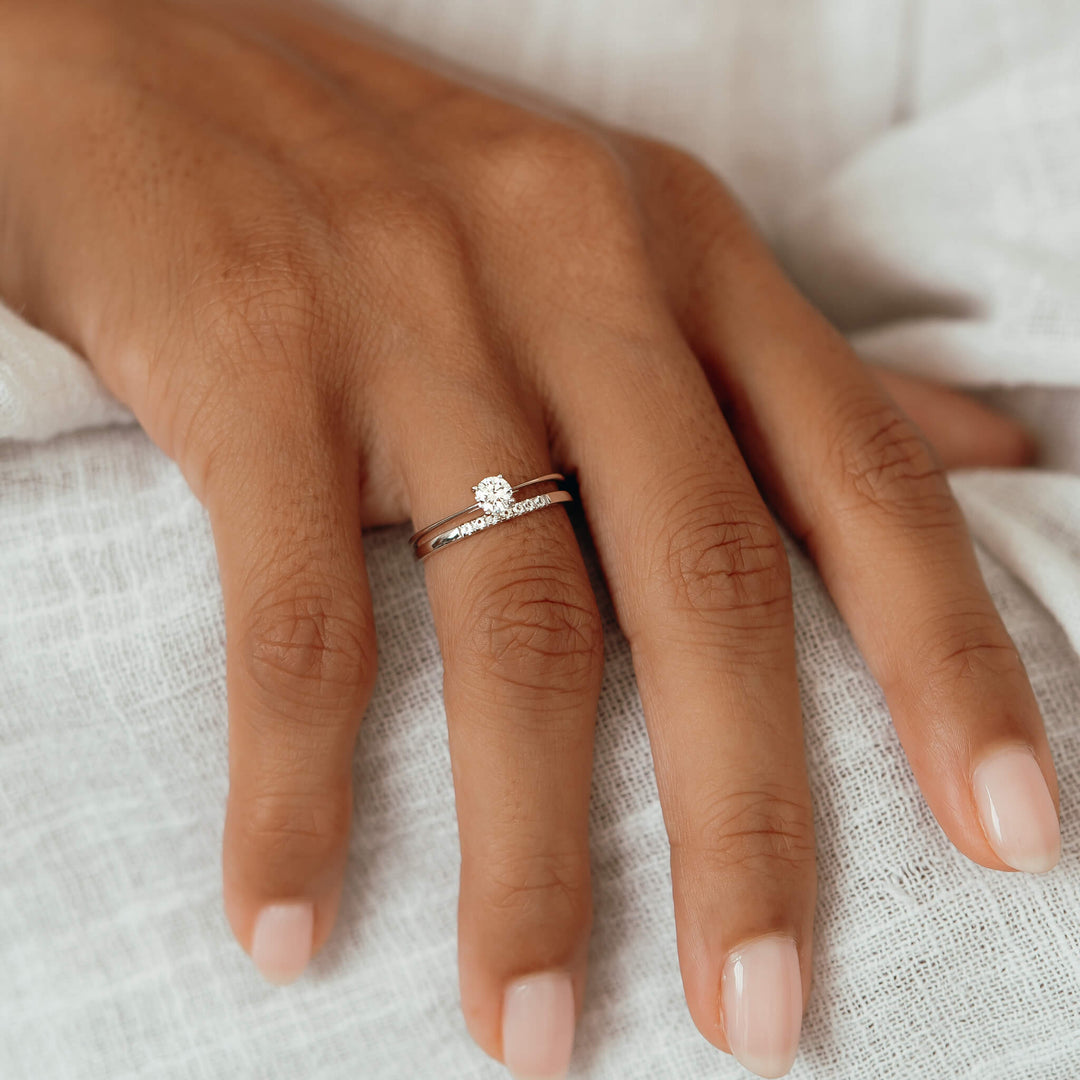 White gold diamond rings stacked on model