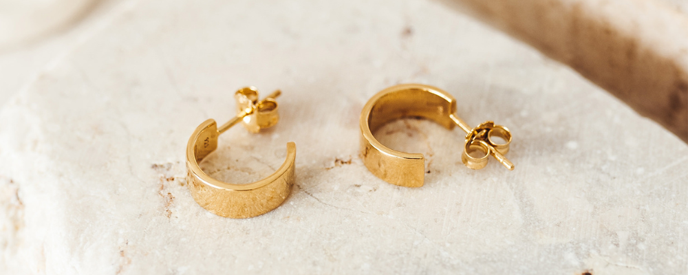Gold Vermeil Chunky Mini Hoop Earrings on table 