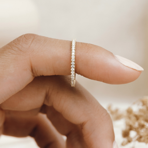 Diamond eternity ring in gold vermeil on finger