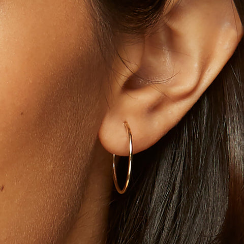 14k Solid Gold Hoop Earrings in 25mm on ear 